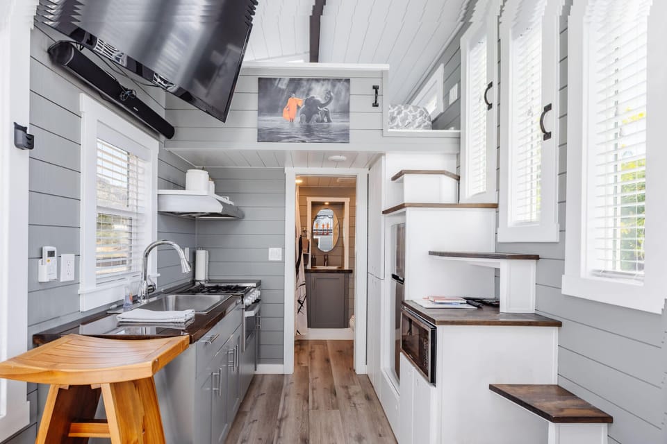 Kitchen fully equipped with a refrigerator, freezer, microwave, stove, oven and sink with hot/cold water. Enjoy coffee from the coffee maker and ample counter space. Essentials include cookware, dishes, utensils, and plenty of storage cabinets.