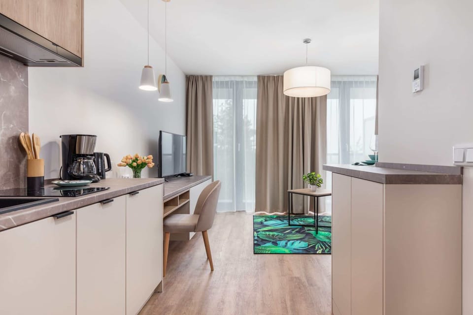 A modern kitchen with wood-accented cabinets, sleek appliances, and ample counter space.
