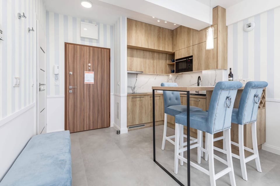 A wide-angle shot showcasing the integration of the living and dining areas in a bright, open space.