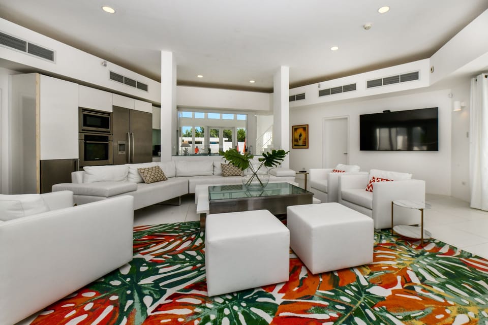 Magnificent Living Area of the Villa in Noord Aruba - Smart TV and Netflix - Beautiful living area with an open layout, creating a sense of spaciousness - Ocean Views from the Living Area  - Comfy seating with lush sofas