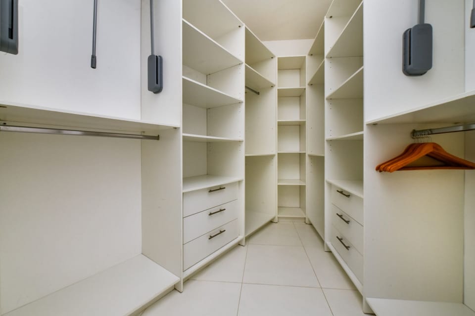 Step into organization and style with our walk-in closet, where ample space and smart storage solutions await to enhance your stay.