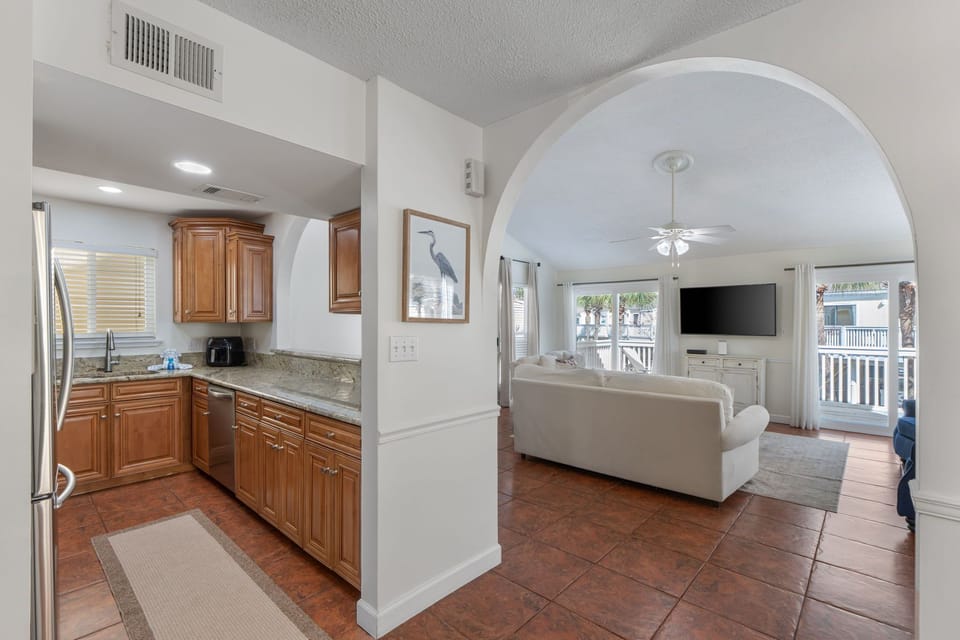 Step into your open-concept retreat where the elegant arched doorway connects your fully equipped kitchen to the bright living space.