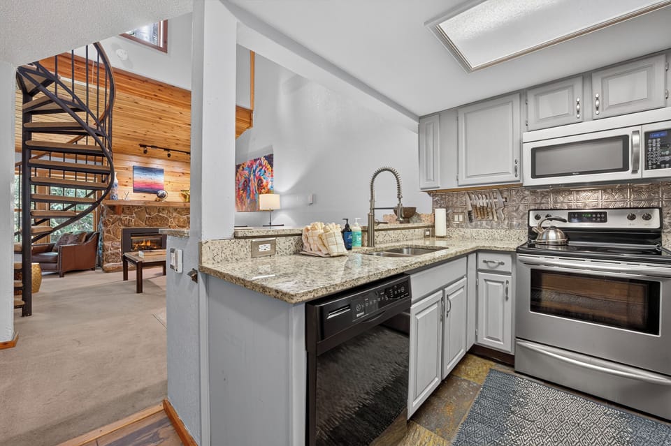 Your fully-equipped kitchen features granite countertops, stainless steel appliances, and a stylish skylight that floods the space with natural light. The open layout invites you to cook and relax in comfort.