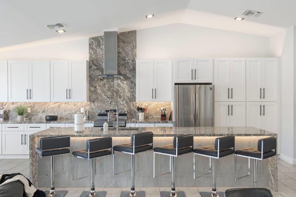 Sleek chef’s kitchen with ample seating.

