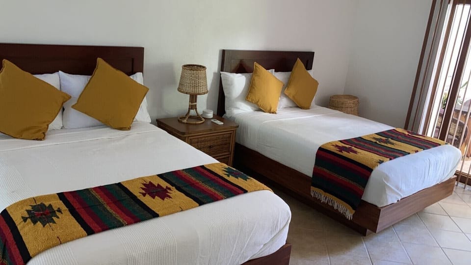 Downstairs bedroom with two double beds and private bath 
