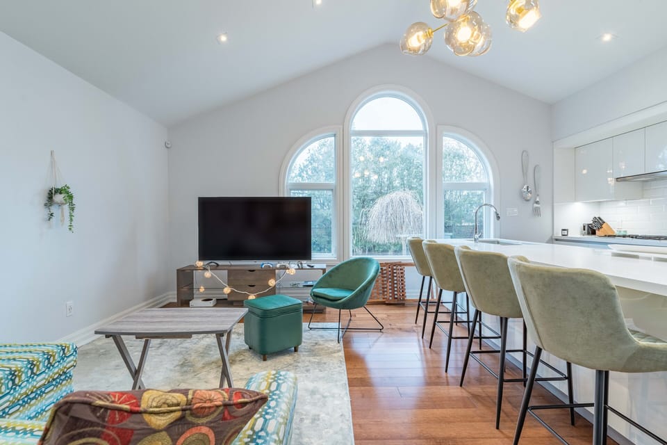 The living area off the kitchen offers more seating and a 65" inch HDTV