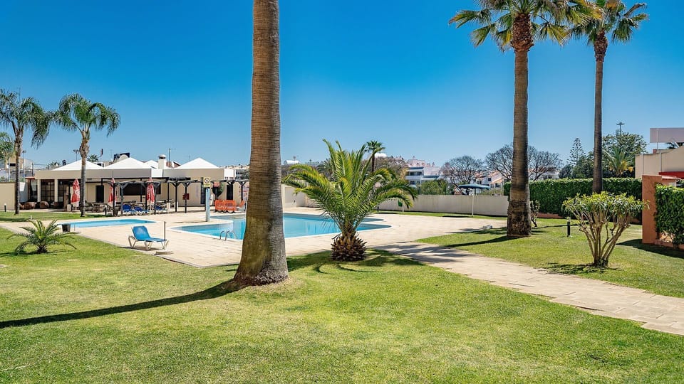 Soak up the sun by the sparkling communal pool, surrounded by lush green lawns and palm trees.
#Poolside #SunnyVibes #LovelyStay