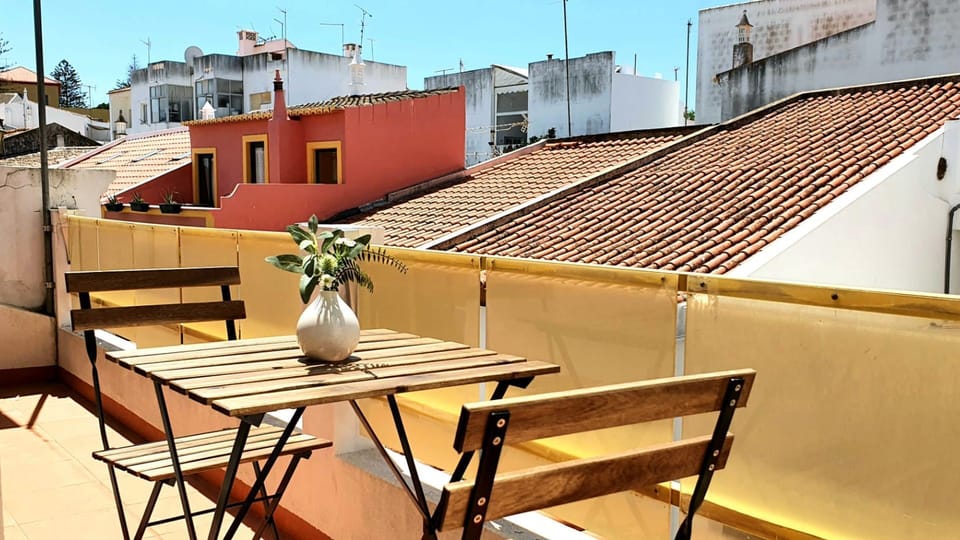 Soak up the sun on your private terrace, offering charming views of the city rooftops.
#Terrace #CityView #LovelyStay