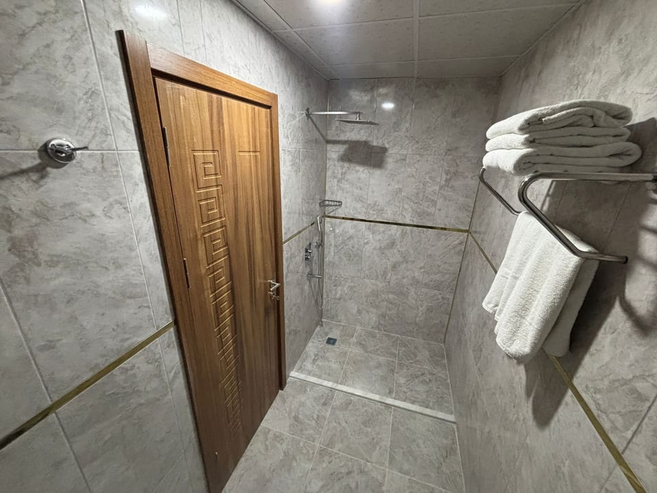 Economy Room (No Window) | Bathroom | Shower, rainfall showerhead, hair dryer, bathrobes