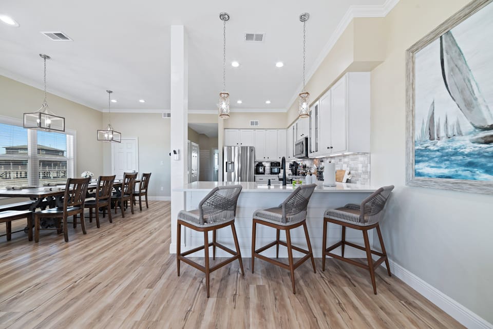 A charming breakfast bar is a convenient and inviting spot to enjoy a quick bite or a cup of Joe. With comfy bar stools, plenty of counter space, and easy access to the kitchen