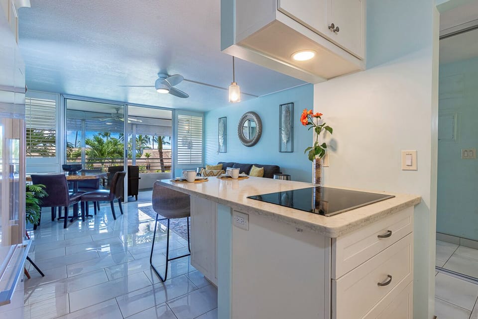 Step into your bright, coastal-inspired space where ocean breezes drift through and palm trees sway just outside your window. The open layout connects your kitchen, dining, and living areas—perfect for relaxed island living.