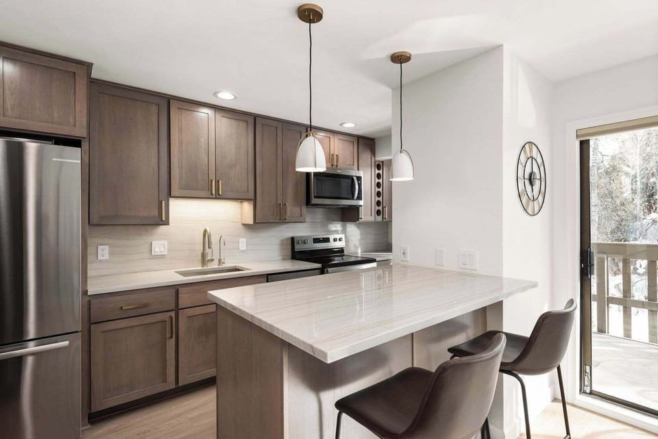 Upgraded, fully equipped kitchen with stainless appliances and quartz countertops