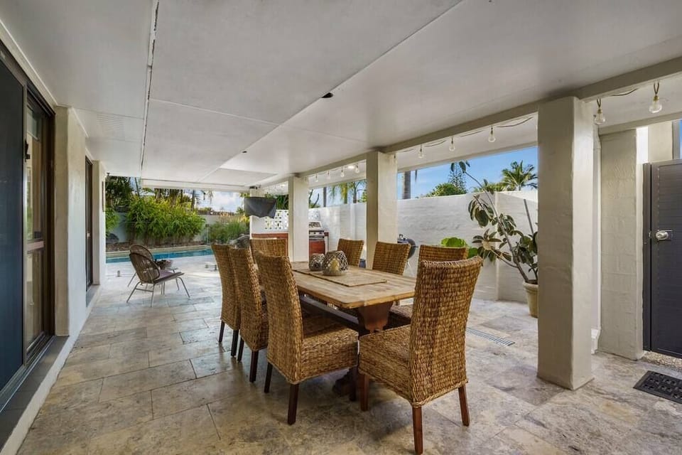 Poolside patio seats eight, with BBQ grill and easy outdoor dining.