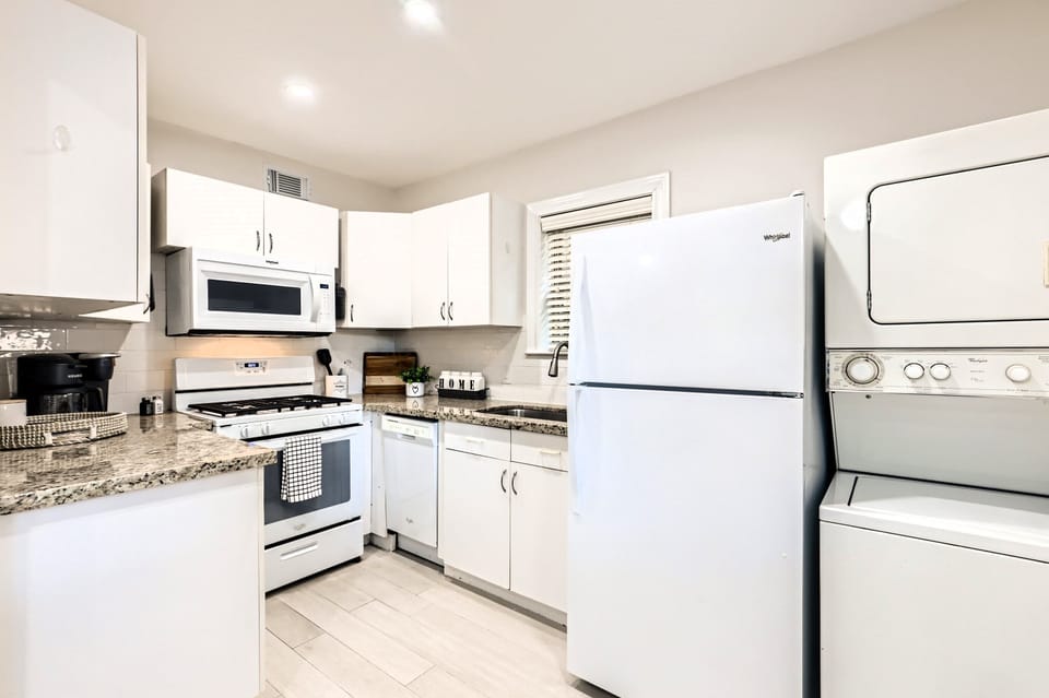 Kitchen includes appliances shown including washer/dryer. 
