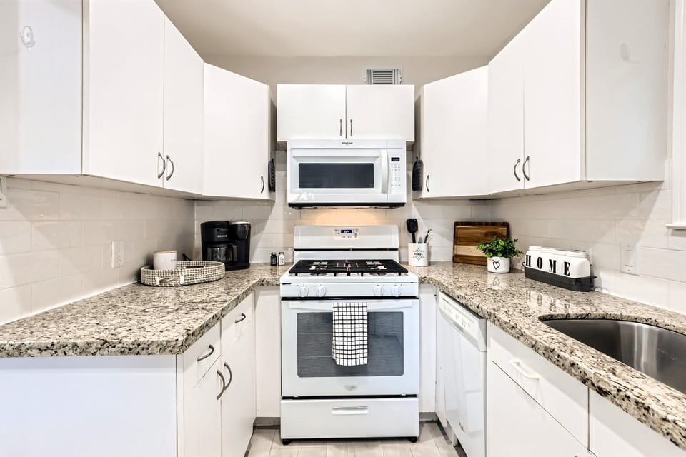 Kitchen includes appliances shown including washer/dryer. 