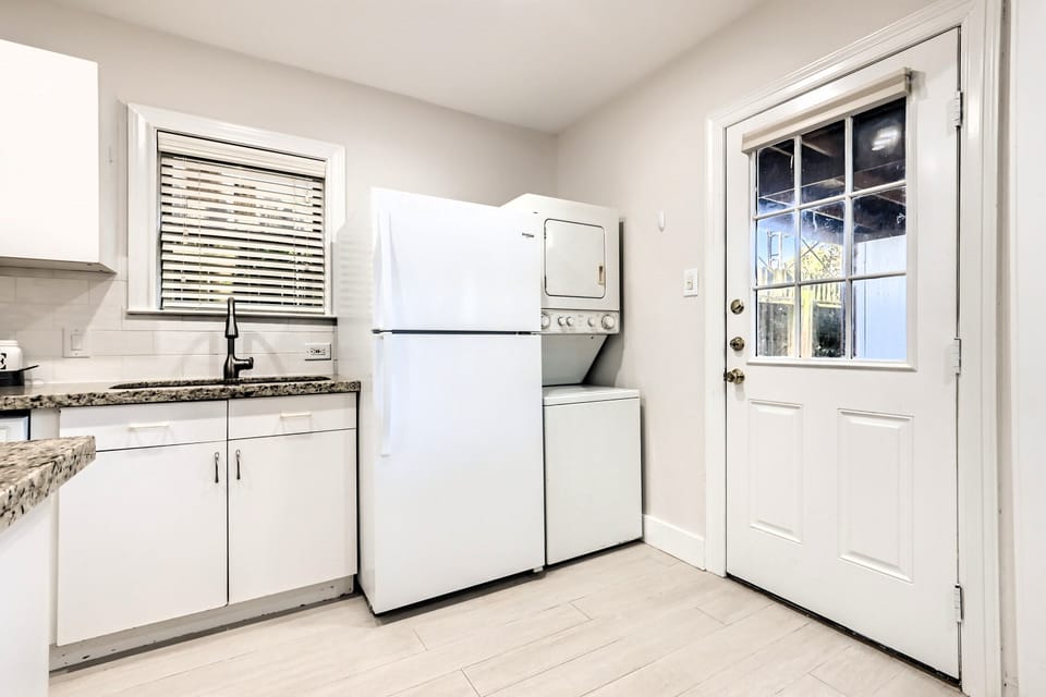 Kitchen includes appliances shown including washer/dryer. Back entry on Right.