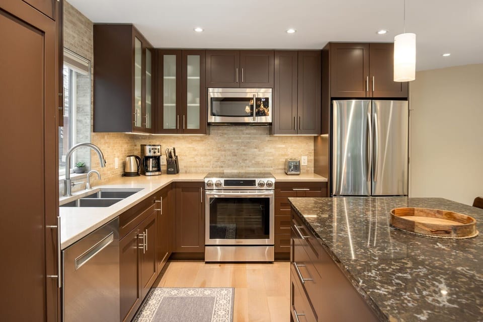 Fully stocked and recently renovated, this kitchen features high-end appliances and sleek stone countertops.