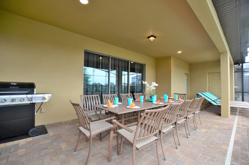 lounge chairs, patio table with seating and BBQ grill