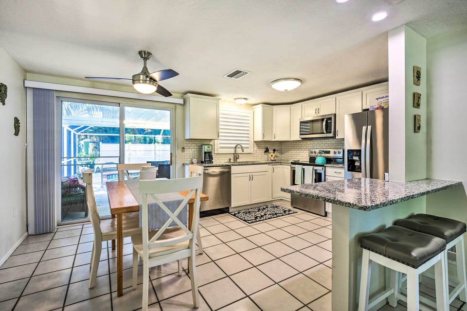 Dining Area | Breakfast Bar w/ Additional Seating | Dishware & Flatware Provided