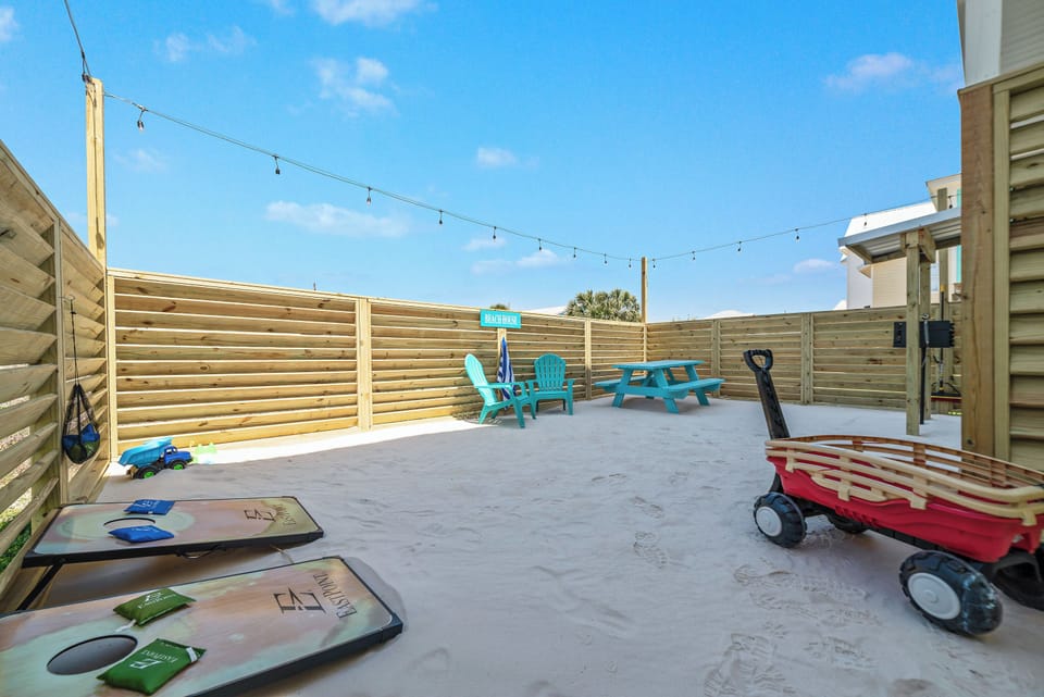 Relax outside in your own enclosed white sand backyard while the kids play.
