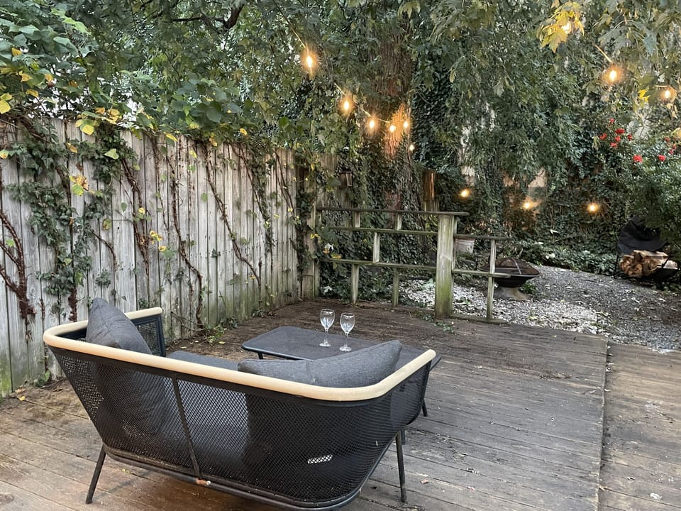Outdoor space with vintage lights, fire pit, gas grill