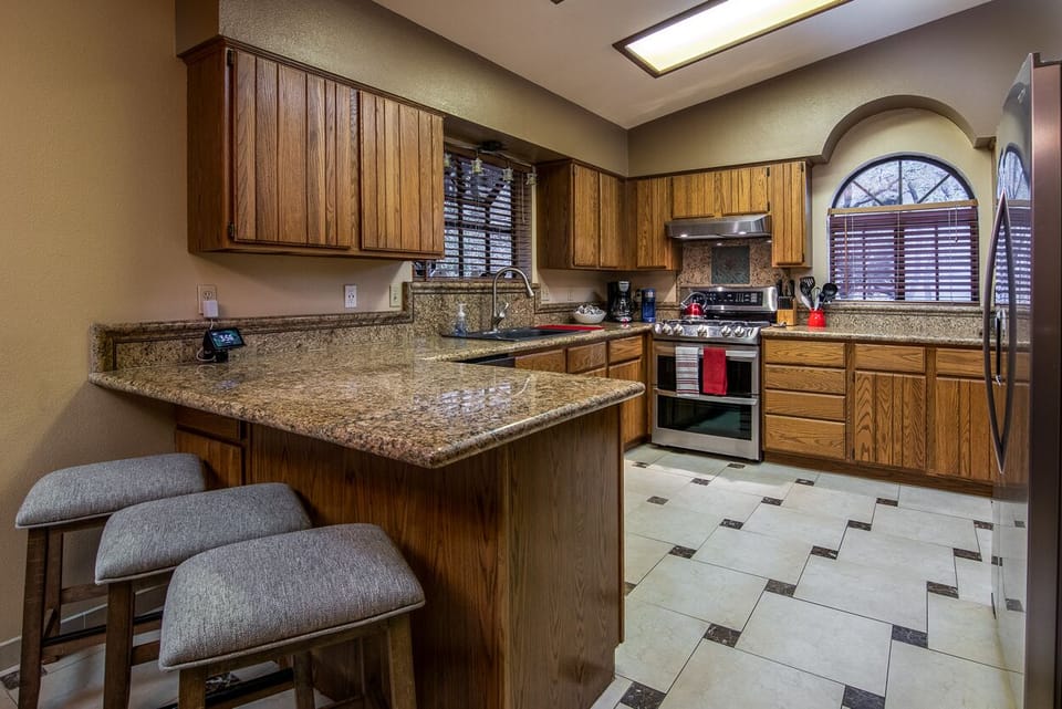 Full kitchen with drip coffee maker, k-cup style coffee maker, and breakfast bar