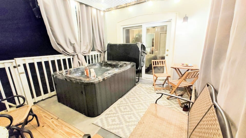 Relax in the hot tub just outside the master bedroom. Privacy curtains.