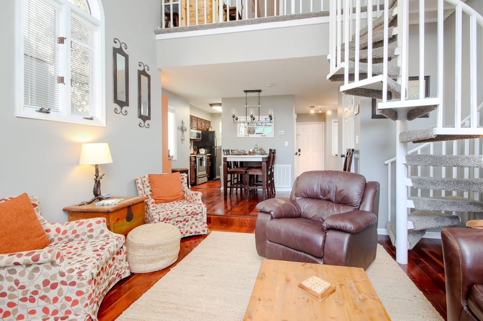 Living room is open to kitchen. We love the big windows and all the light.