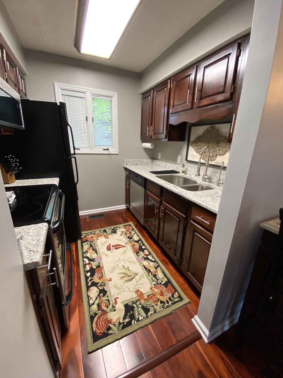Kitchen is equipped with toaster, blender, mixer, crockpot, knives, pot and pans
