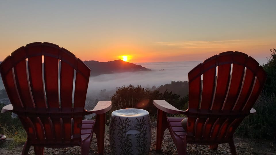 Backyard view: Sun sets over Pedro Point with low fog rolling in. 