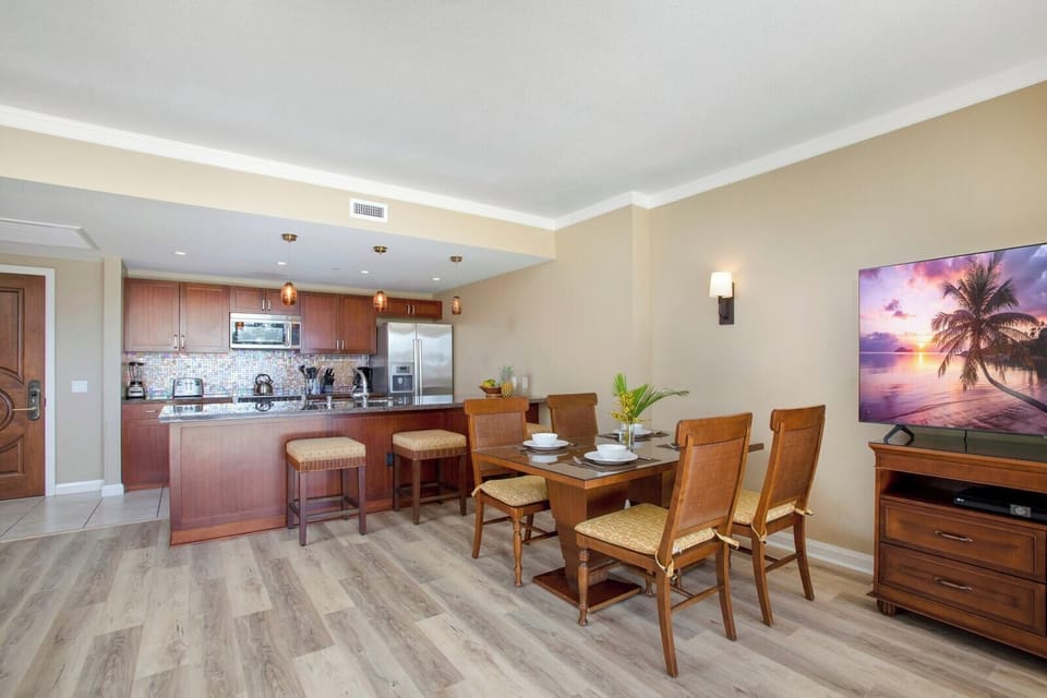 Modern kitchen and dining blend comfort, style, and island charm.