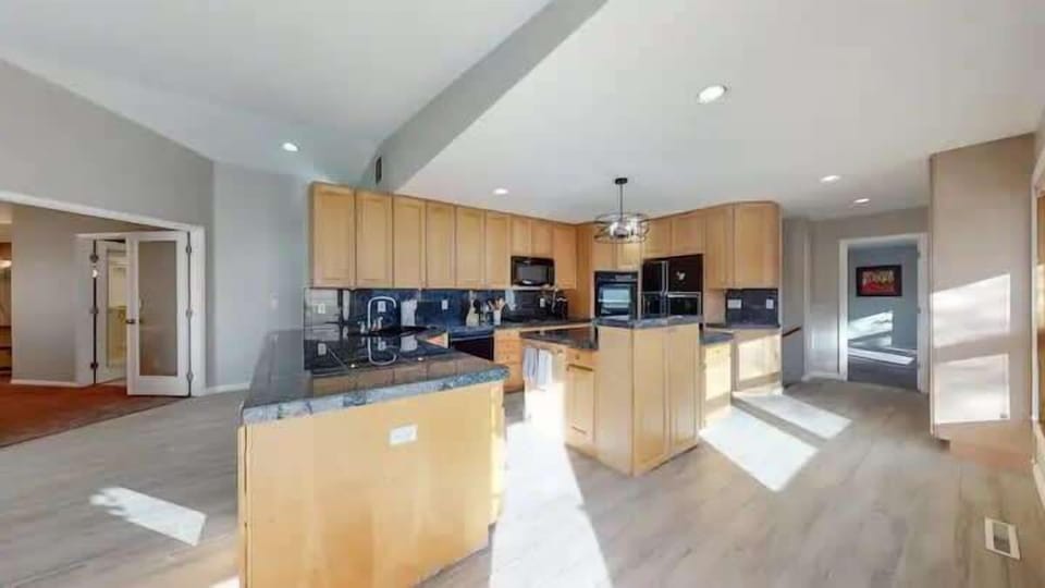 Spacious kitchen with black appliances