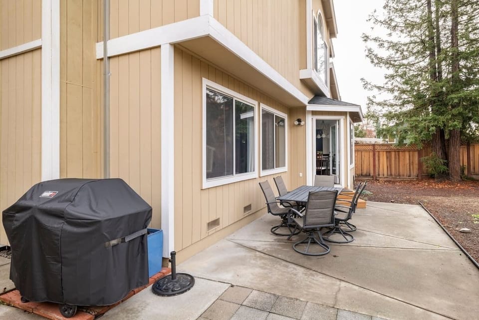 Backyard with propane BBQ and dining tables.  Fully fenced. 