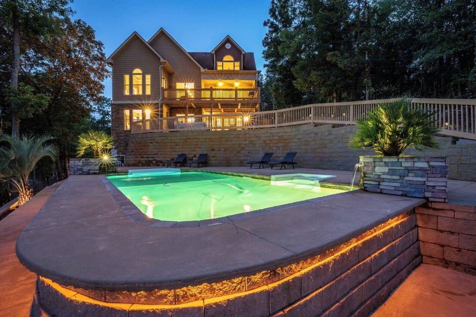 Pool gazing up at Lake Harding lakefront home