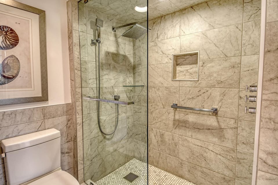 Spa-inspired bathroom with glass-enclosed rainfall shower