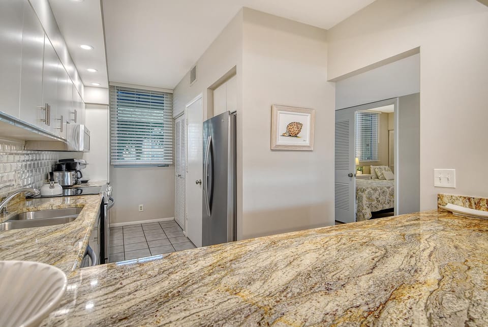 Bright, modern kitchen with granite countertops and stainless steel appliances