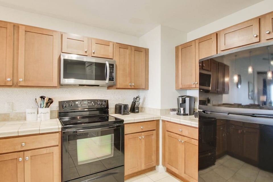 Kitchen complete with microwave + stove + blender + keurig + dishwasher + dishware + cooking & eating utensils!