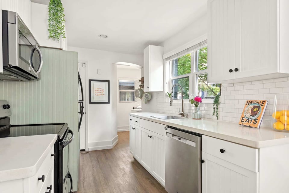 The bright and airy kitchen has been renovated with stainless steel appliances and dishwasher