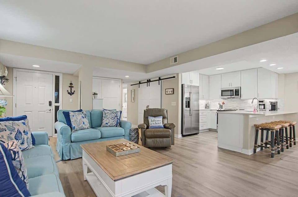 Your coastal-inspired retreat welcomes you with plush teal seating and a gleaming kitchen, perfect for relaxing and creating memories together.