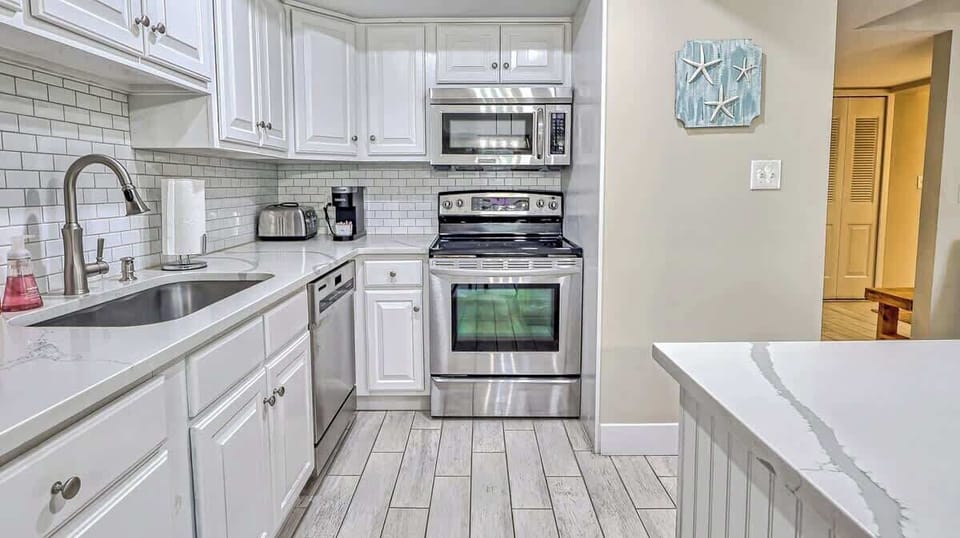 Modern kitchen with stainless steel appliances and white cabinetry