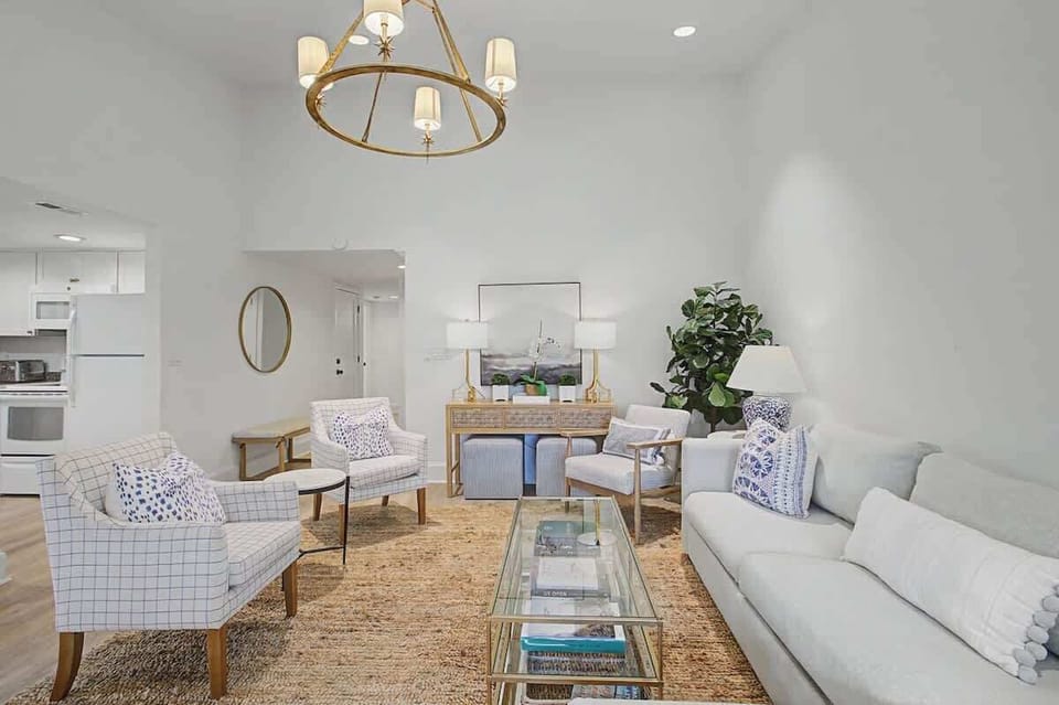 Sink into plush seating surrounded by designer touches and warm natural light in this elegant living space.