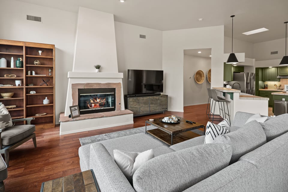Cozy yet spacious, the room invites relaxation, whether you're curled up by the fireplace or basking in the natural light that fills the space.