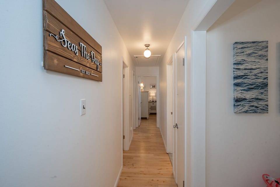 Hallway Leading from the Entrance Foyer to 3 Bedrooms of the Property 