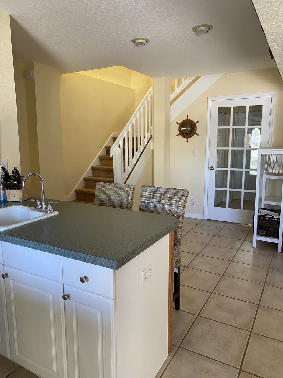 Stairs leading to downstair common space with kitchen, bath and outdoor access