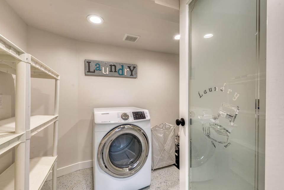 Laundry room in the basement with lots of storage