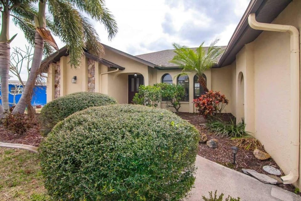 Welcome to your tropical escape! Step into paradise with lush greenery and warm Florida charm right at your doorstep.