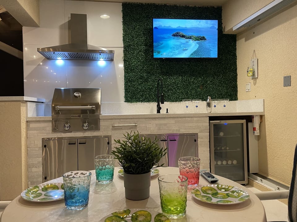 Outdoor Kitchen with Dining Table at Night