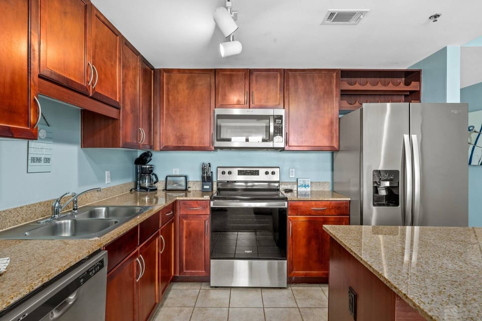 Fully equipped kitchen with full sized stainless steel appliances and service for 12