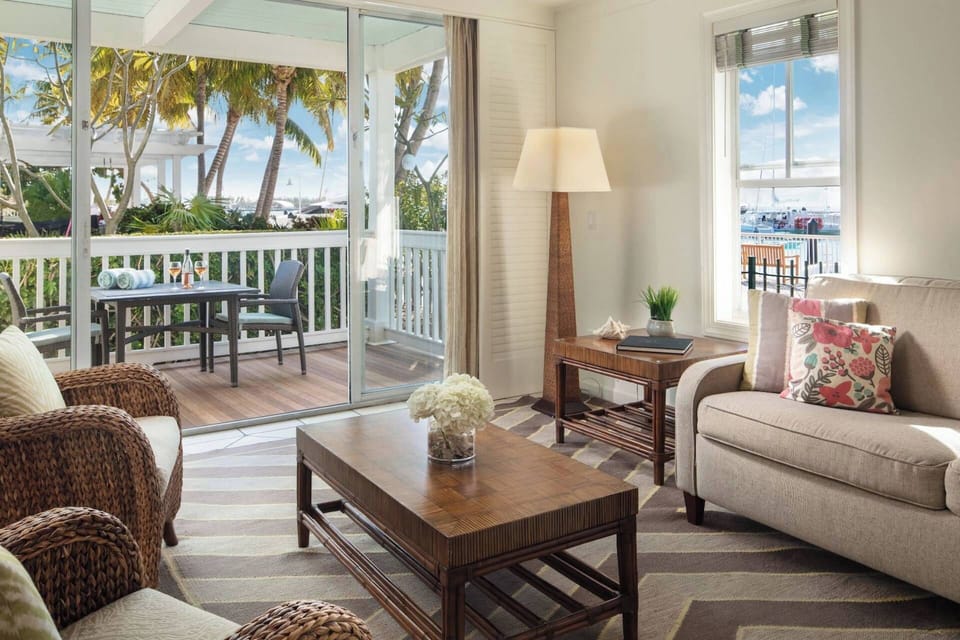Spacious living room with furnished balcony.