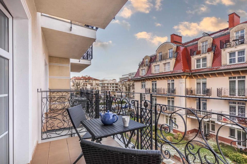 Spacious balcony with outdoor furniture. 